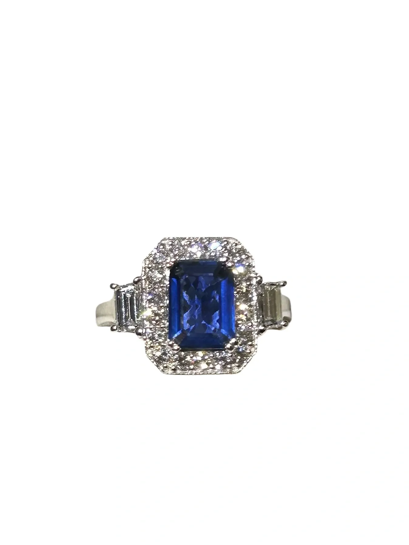 Emerald-cut sapphire ring with diamond halo