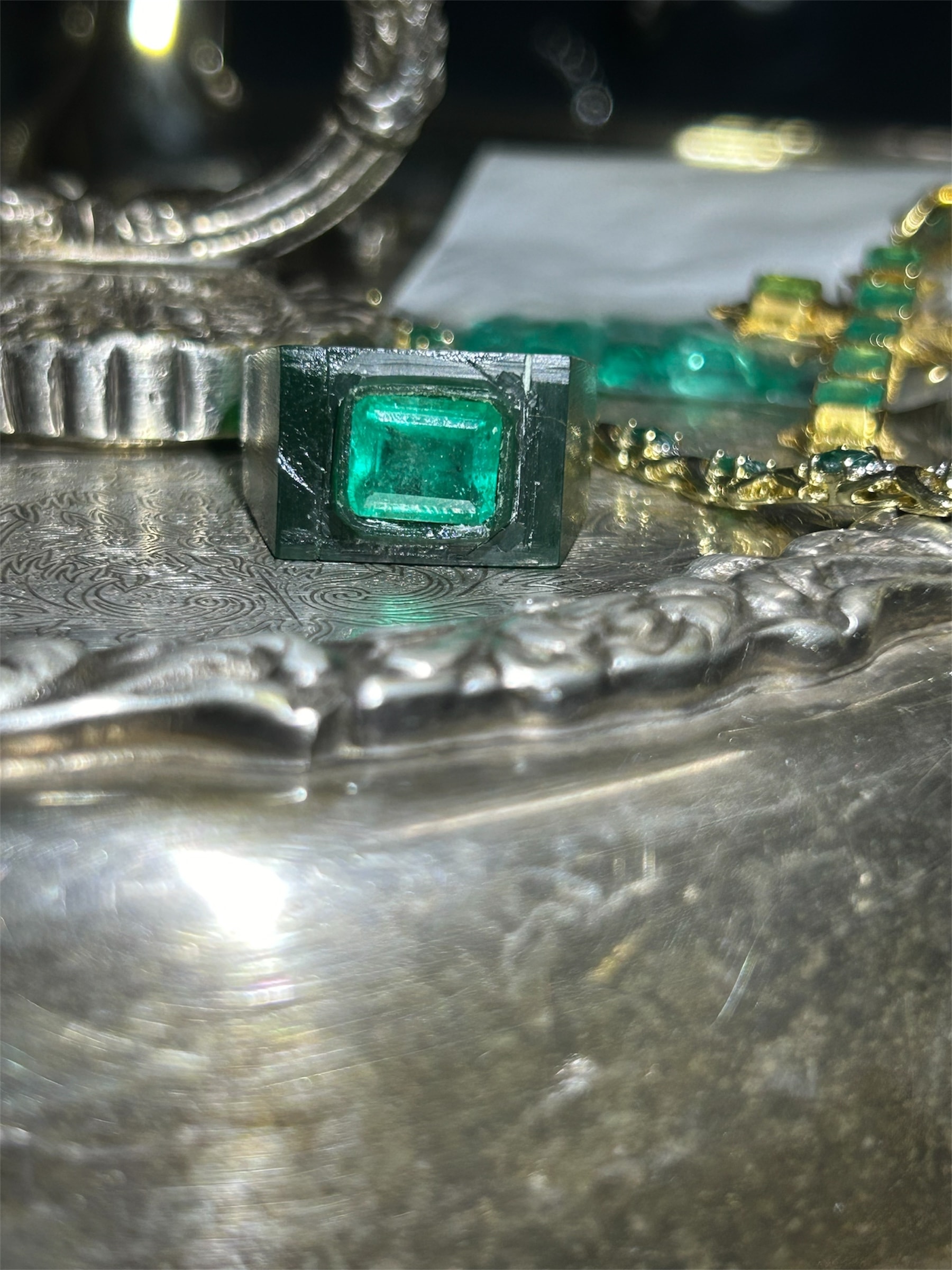 Emerald stone in ornate setting